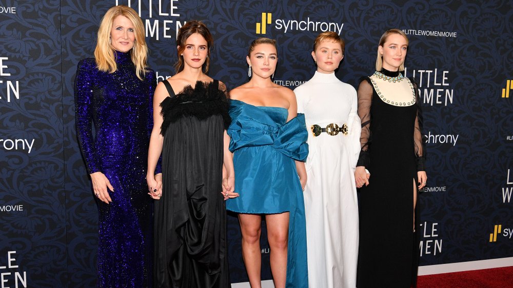 Laura Dern, Emma Watson, Florence Pugh, Eliza Scanlen, and Saoirse Ronan holding hands at the Little Women premiere