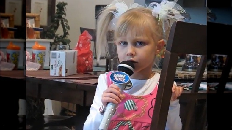 Grace VanderWaal holding toy microphone