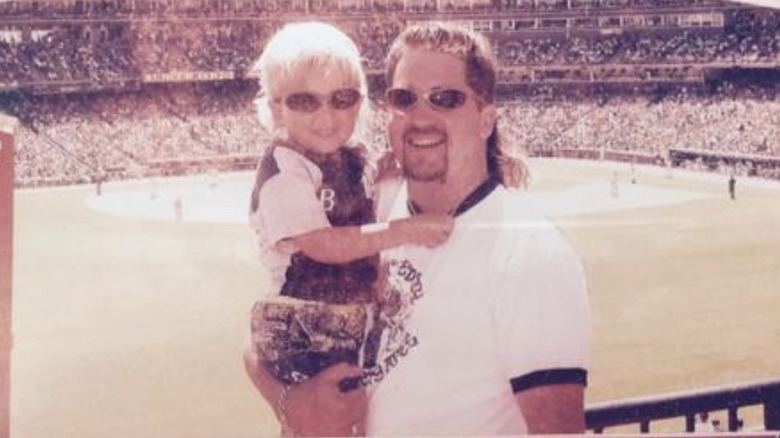 Guy Fieri holding son at stadium