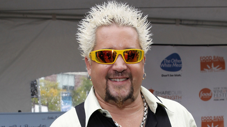 Guy Fieri wearing sunglasses, smiling