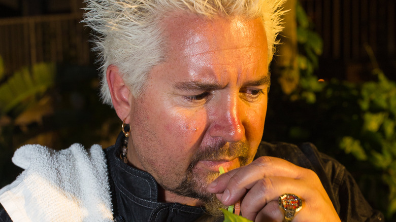 Guy Fieri sipping a drink