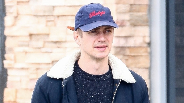 Hayden Christensen in ballcap with furrowed brow