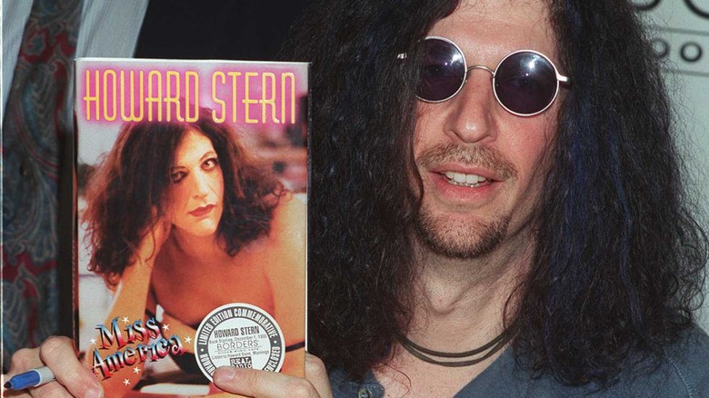 Howard Stern holding book