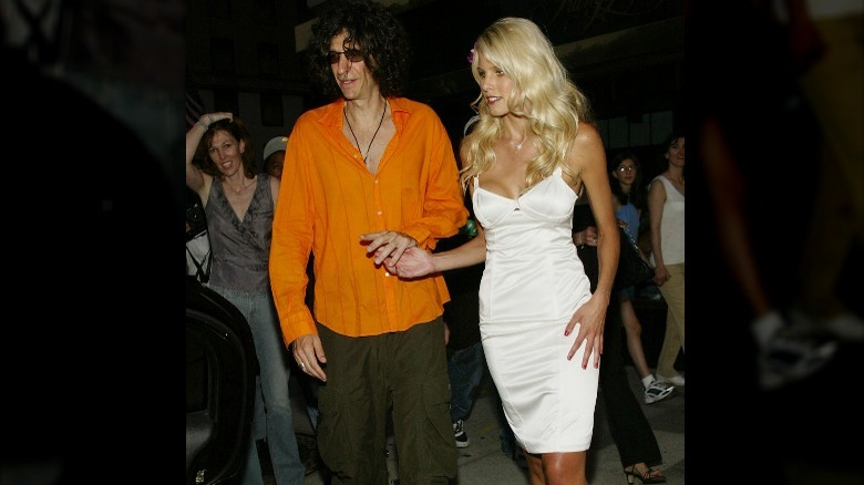 Howard Stern holding hands with Beth Ostrosky 