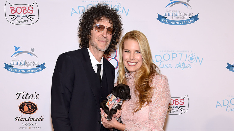 Howard Stern and Beth Ostrosky holding puppy