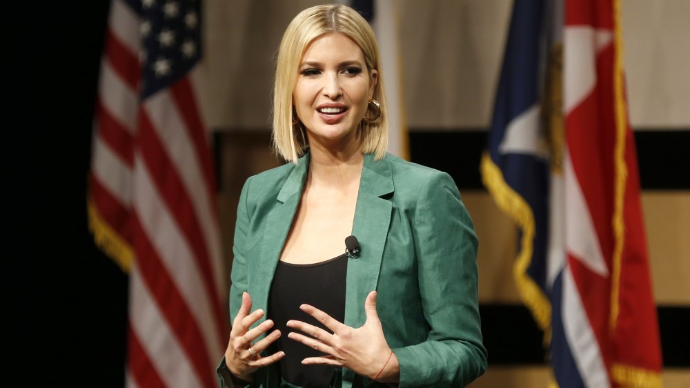 Ivanka Trump in a green blazer and black top, speaking