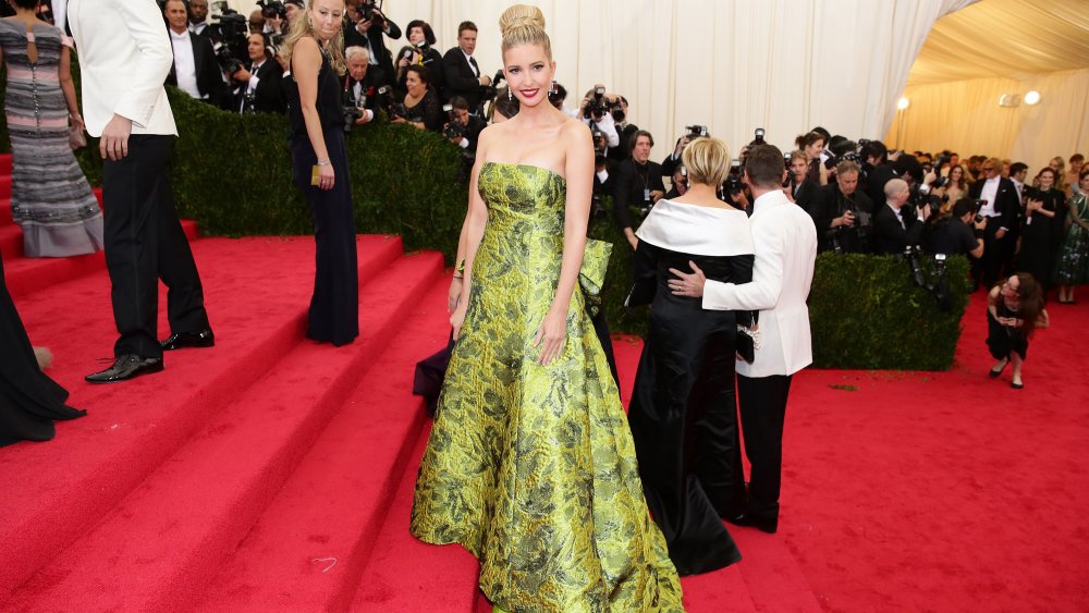 Ivanka Trump in a green floral dress, her hair in an up-do, at the 2014 Met Gala