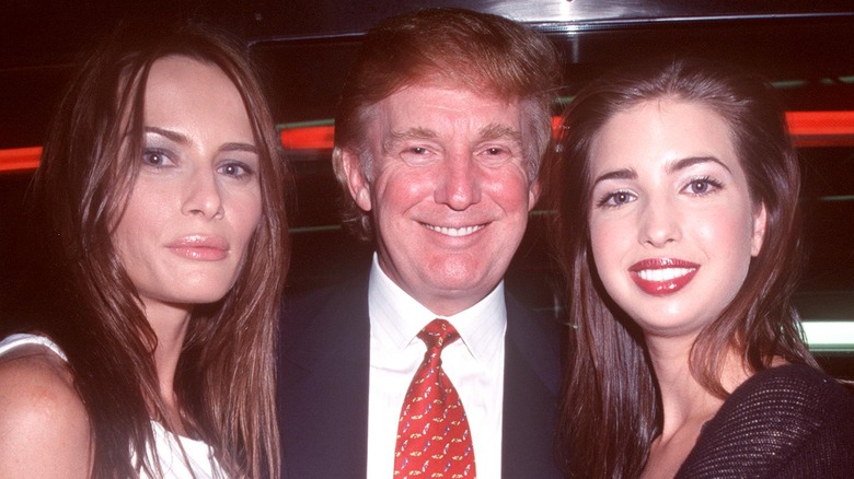 Melania Trump, Donald Trump, and Ivanka Trump posing together in 2000