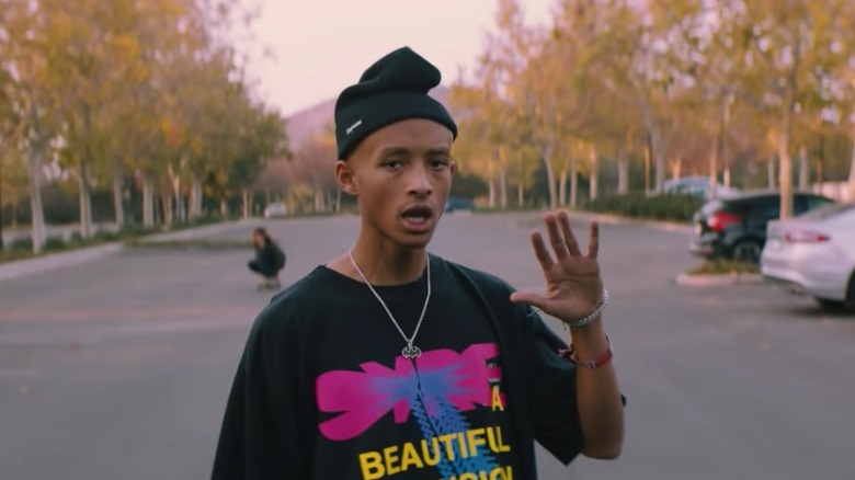 Jaden Smith holding his palm out to the camera in a beanie