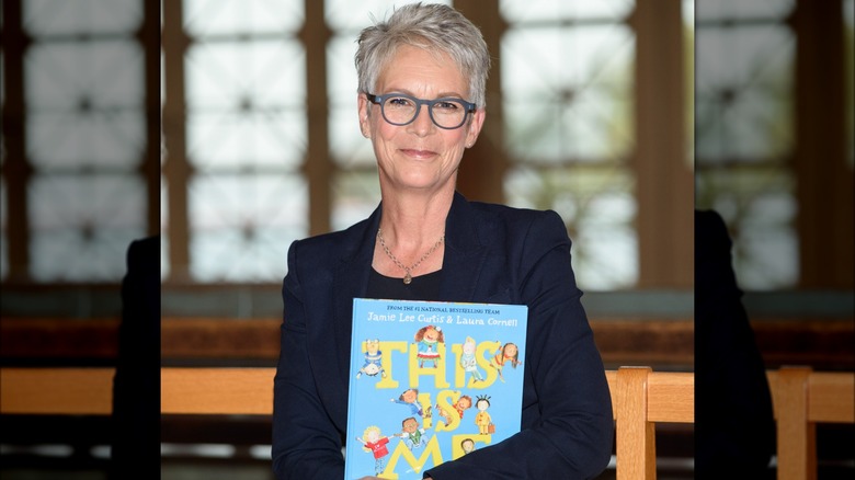 Jamie Lee Curtis posing with one of her books