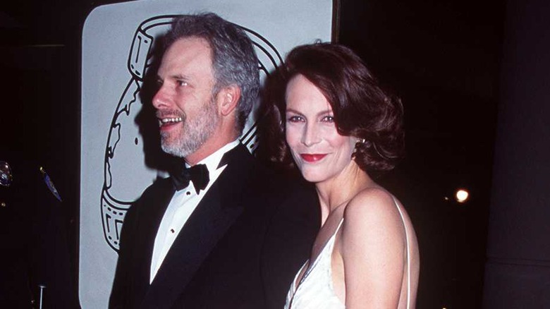 Jamie Lee Curtis posing with Christopher Guest in the '90s