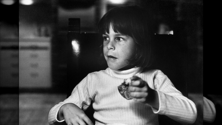 Jamie Lee Curtis holding food as a child in the 1960s