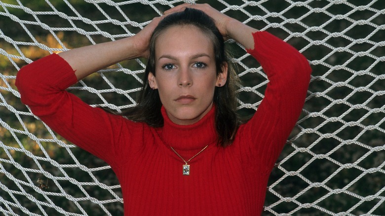 Jamie Lee Curtis posing in a red long-sleeved shirt in 1978