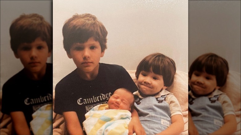 Jared Padalecki next to his brother, who is holding their newborn sister