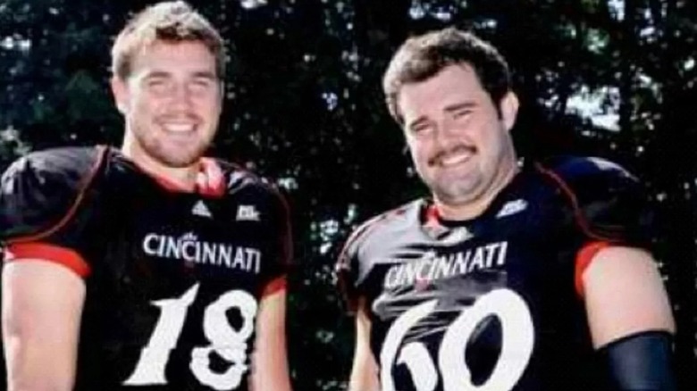 Travis and Jason Kelce posing in University of Cincinnati jerseys