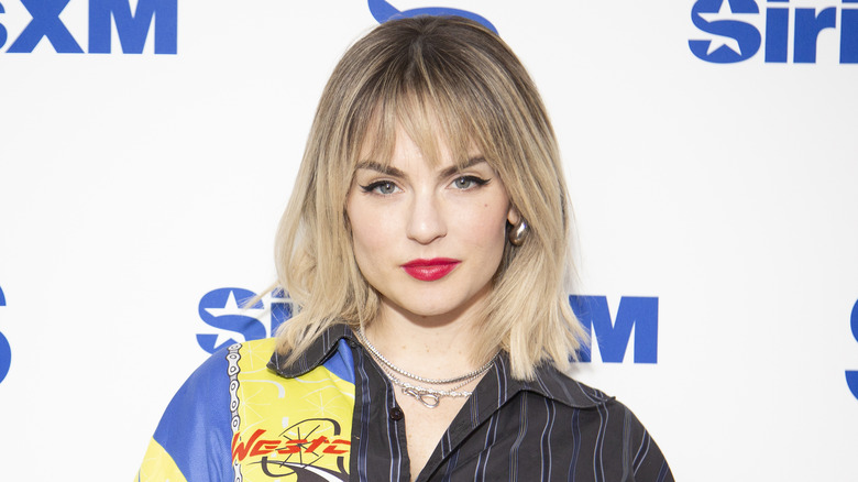 Joanna "Jojo" Levesque wearing a multi-patterned top and small silver necklaces