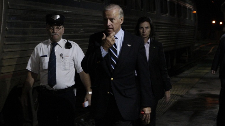 Joe Biden walking in front of train