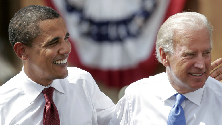 Barack Obama and Joe Biden smiling on stage