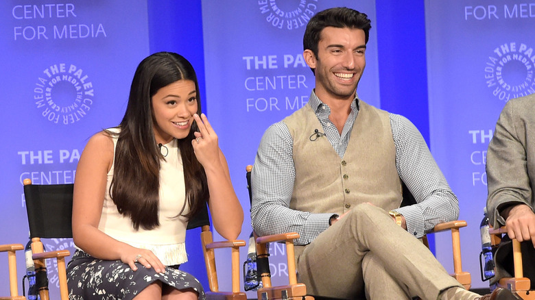 Gina Rodriguez and Justin Baldoni smiling on stage