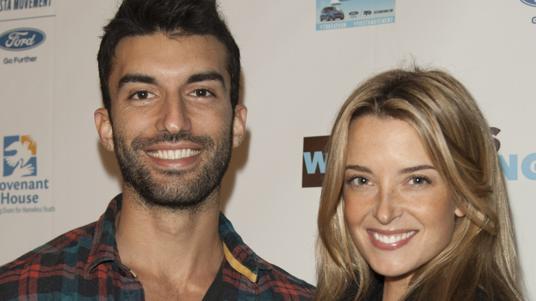 Emily and Justin Baldoni smiling on the red carpet