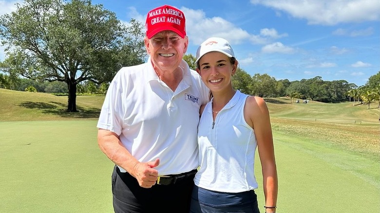 Kai and Donald Trump pose on the golf course