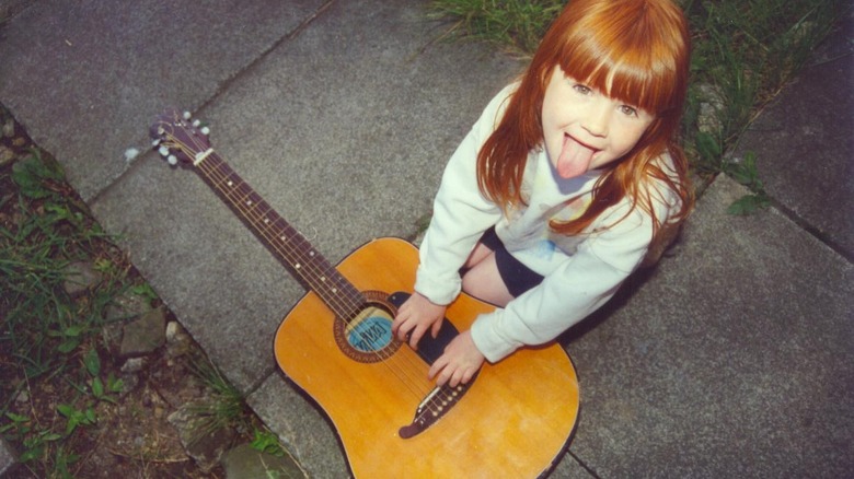 Young Karen Gillan with guitar