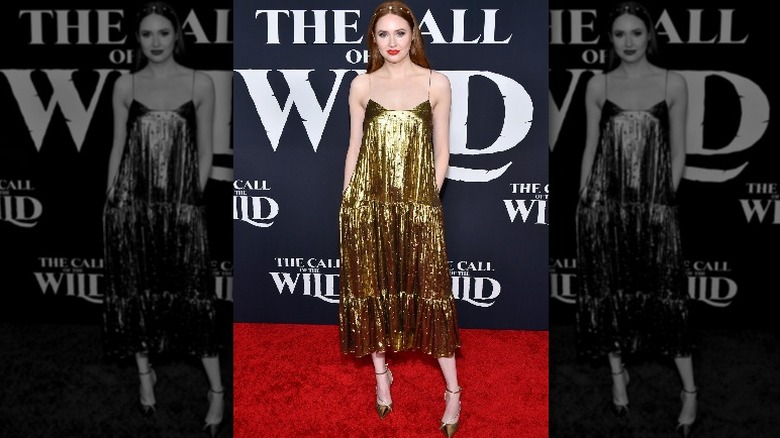 Karen Gillan posing gold dress
