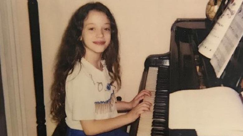 Kat Dennings playing piano as a child