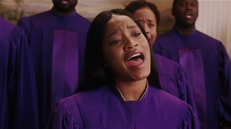 Keke Palmer in a purple gospel robe, singing