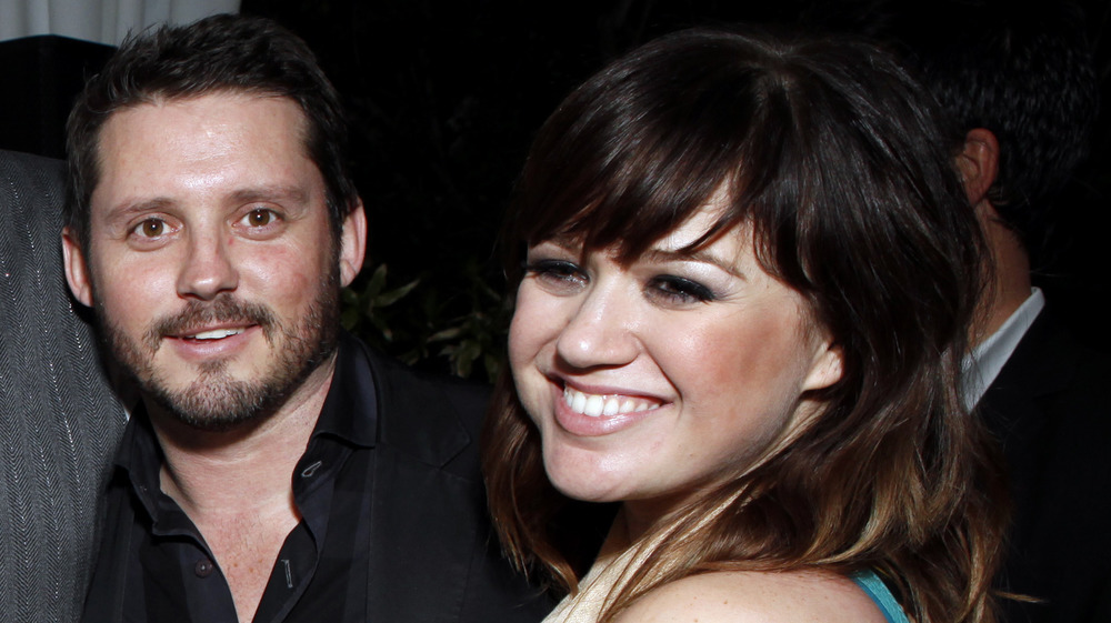 Kelly Clarkson and Brandon Blackstock smiling together in 2012