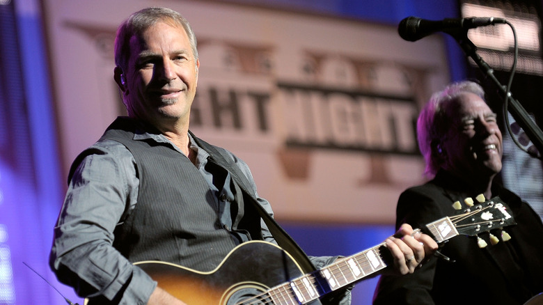 Kevin Costner with a guitar