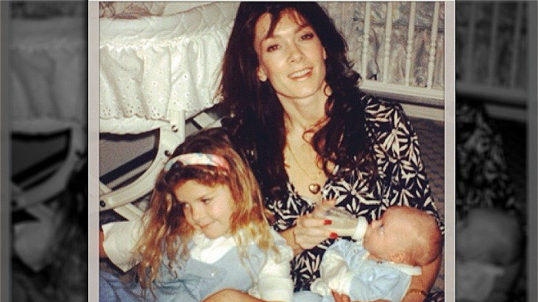 Lisa Vanderpump sitting with her children, while feeding a bottle to baby Max