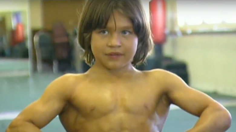 Little Hercules, Richard Sandrak, posing in a gym