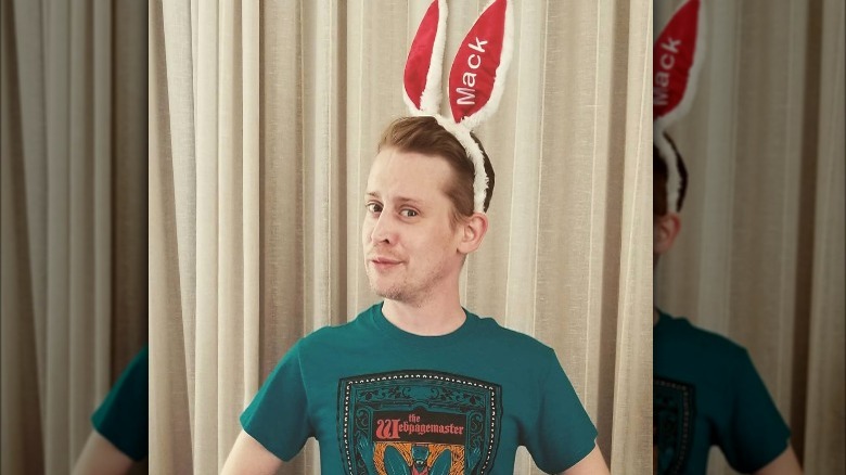 Macaulay Culkin wearing bunny ears