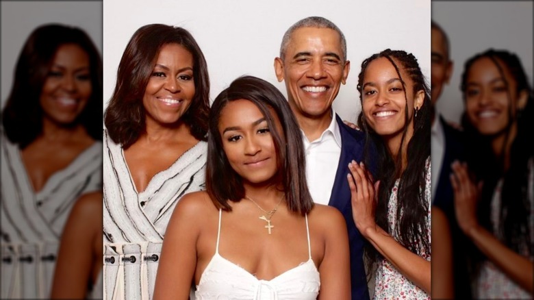 Malia Obama with Michelle, Sasha, and Barack Obama posing