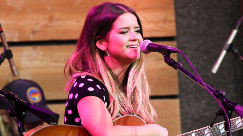 Maren Morris playing the guitar