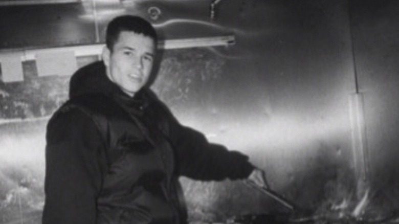 Young Mark Wahlberg flipping a burger.