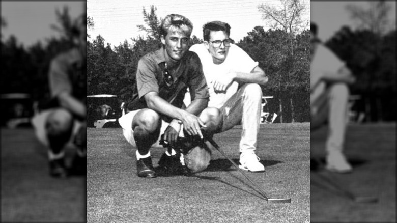 Matthew McConaughey holding golf club with friend