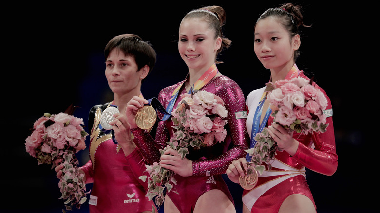 McKayla Maroney holds up gold medal