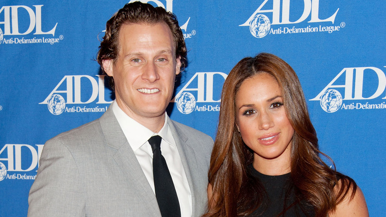 Trevor Engelson and Meghan Markle at an event