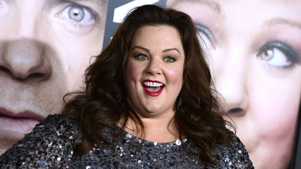 Melissa McCarthy in a black, sequined dress, smiling big at The Thief premiere