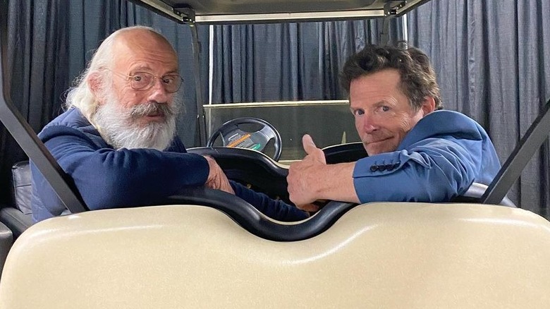 Christopher Lloyd sitting beside Michael J. Fox