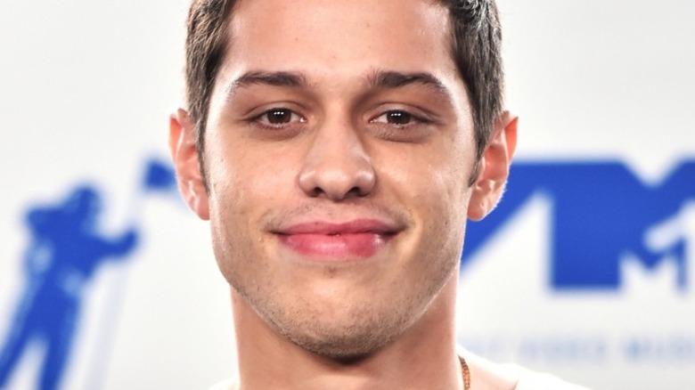 Pete Davidson smirking