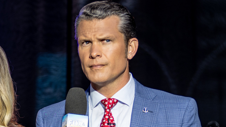 Pete Hegseth holding a Fox News microphone