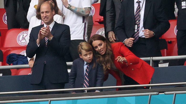 Kate Middleton leaning down to speak to Prince George