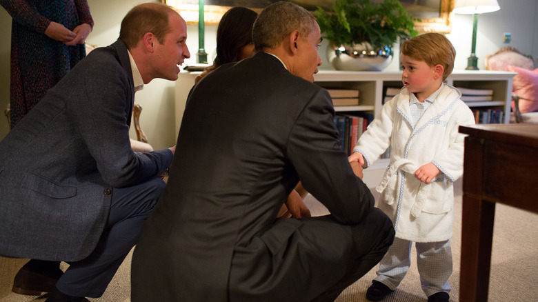 Barack Obama shaking Prince George's hand