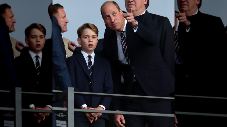 Prince William pointing beside Prince George