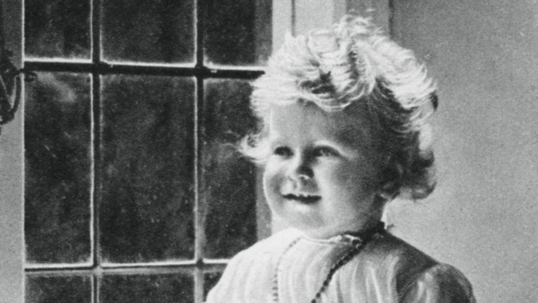 Queen Elizabeth sitting near a window in 1927.