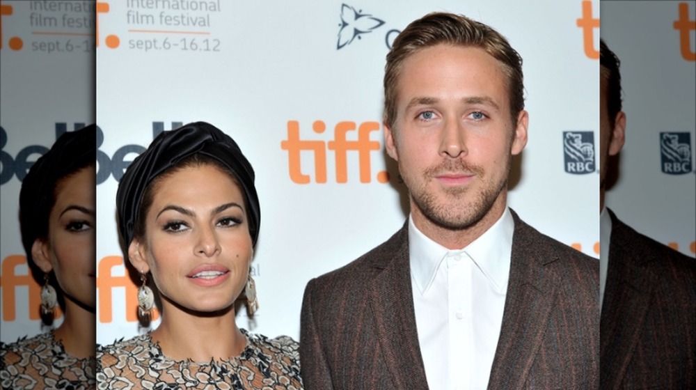 Eva Mendes and Ryan Gosling posing side by side.