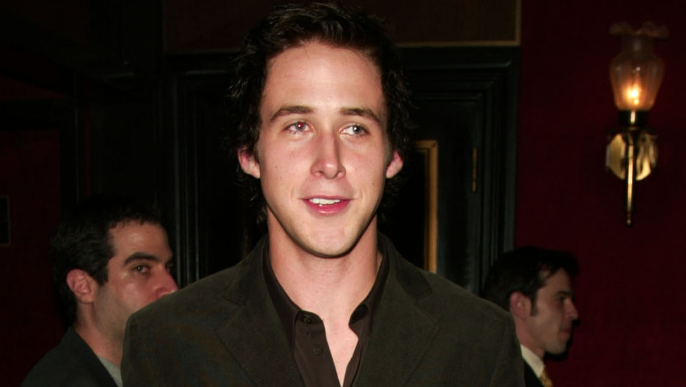 Ryan Gosling posing in a brown blazer in 2004